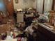 The dining room shows a lot of clutter on the table, floor, and countertop at 6736 E Michigan St, Indianapolis, IN 46219
