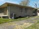 Cozy home features stone accents, a well-kept lawn and an asphalt driveway for easy parking and access to the property at 6736 E Michigan St, Indianapolis, IN 46219