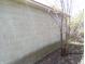 Exterior concrete block wall with some plant and tree growth at 6736 E Michigan St, Indianapolis, IN 46219