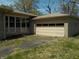 Single car detached garage with classic design, providing convenient parking and storage space for the residence at 6736 E Michigan St, Indianapolis, IN 46219