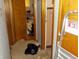 The hallway has garbage and clutter and leads to rooms with wood trim doorways at 6736 E Michigan St, Indianapolis, IN 46219