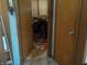 The hallway shows a mess and clutter near an open doorway with wood trim at 6736 E Michigan St, Indianapolis, IN 46219