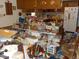The kitchen has clutter on the counter, island, and floor, with wood cabinets at 6736 E Michigan St, Indianapolis, IN 46219