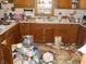The kitchen features wood cabinets, a window over the sink, and items scattered around at 6736 E Michigan St, Indianapolis, IN 46219