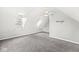 Large attic space with neutral walls, dormer windows, and plush carpeting at 6758 Woodcliff Cir, Zionsville, IN 46077