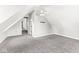 A carpeted attic with sloped ceilings and a fan creates a roomy upper-level space at 6758 Woodcliff Cir, Zionsville, IN 46077
