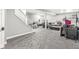 Unfinished basement providing ample storage with carpeting, a sofa, and staircase at 6758 Woodcliff Cir, Zionsville, IN 46077