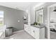 Inviting bathroom with double vanity, granite countertops, and decorative mirror with cabinet at 6758 Woodcliff Cir, Zionsville, IN 46077