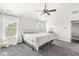Spacious bedroom with ceiling fan, two windows offering natural light and neutral carpeting at 6758 Woodcliff Cir, Zionsville, IN 46077