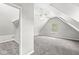 Bright and airy bonus room in attic features neutral walls, carpet, and ceiling fan at 6758 Woodcliff Cir, Zionsville, IN 46077