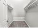 Walk-in closet with ample storage, carpeted floors, and built-in shelving for organization at 6758 Woodcliff Cir, Zionsville, IN 46077