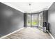 Elegant dining room featuring wood-look floors, a modern light fixture, and bright bay windows at 6758 Woodcliff Cir, Zionsville, IN 46077