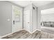 Charming foyer features stylish front door with decorative glass and wood-look floors at 6758 Woodcliff Cir, Zionsville, IN 46077