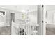 Upstairs hallway view of carpeted floor, white railings, and natural light through window at 6758 Woodcliff Cir, Zionsville, IN 46077