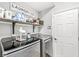 Well-organized laundry room with modern washer, dryer, shelving and plenty of storage at 6758 Woodcliff Cir, Zionsville, IN 46077