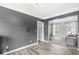 Spacious living room features wood-look flooring and flows into the carpeted sitting area with natural light at 6758 Woodcliff Cir, Zionsville, IN 46077