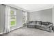 Inviting living room with plush carpeting, neutral paint and large windows offering serene views at 6758 Woodcliff Cir, Zionsville, IN 46077