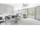 Bright living room featuring comfortable seating, a ceiling fan, plush carpet, and natural light at 6758 Woodcliff Cir, Zionsville, IN 46077