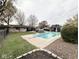 Relaxing backyard with in-ground pool, diving board, a cabana, and mature trees at 6811 S Meridian St, Indianapolis, IN 46217