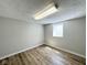 Finished basement room featuring updated floors and natural light at 6811 S Meridian St, Indianapolis, IN 46217