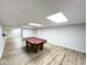 Large finished basement space with wood-look floors and ample lighting at 6811 S Meridian St, Indianapolis, IN 46217