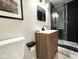 Modern bathroom with sleek vanity, walk-in shower with black accents, and neutral walls at 6811 S Meridian St, Indianapolis, IN 46217
