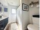 Modern bathroom with a double vanity, black fixtures, and wood-look flooring at 6811 S Meridian St, Indianapolis, IN 46217