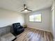 Comfortable bedroom with a relaxing chair and wood-look flooring at 6811 S Meridian St, Indianapolis, IN 46217