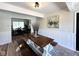 Charming dining room boasts modern table with benches and views to other living spaces at 6811 S Meridian St, Indianapolis, IN 46217