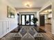 Elegant dining area with wainscoting, a modern table, and views to kitchen and back patio at 6811 S Meridian St, Indianapolis, IN 46217