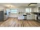 Open kitchen boasts stainless steel appliances, wood floors, and lots of cabinet space at 6811 S Meridian St, Indianapolis, IN 46217