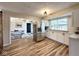 Spacious kitchen boasts stainless appliances, white cabinets, and wood floors at 6811 S Meridian St, Indianapolis, IN 46217