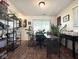 Bright office space with hardwood floors, a large window, and decorative shelving at 6811 S Meridian St, Indianapolis, IN 46217