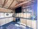 Pool house interior with custom bar, cabinets, beverage fridge, and decor at 6811 S Meridian St, Indianapolis, IN 46217