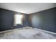 Spacious carpeted bedroom featuring window and neutral color scheme at 6814 Summer Time Dr, Indianapolis, IN 46226