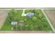 Expansive aerial view of a blue home with a large, well-maintained yard, garden, and outbuilding, surrounded by farm fields at 7020 N 375 E, Lebanon, IN 46052