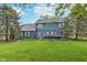 Expansive backyard featuring a well-maintained lawn, mature trees, and a patio with outdoor furniture at 7020 N 375 E, Lebanon, IN 46052