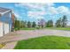 Spacious backyard with a basketball court, lush green lawn, mature trees, and a detached garage at 7020 N 375 E, Lebanon, IN 46052