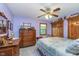 Bedroom with antique furniture, ceiling fan, and soft lighting, showcasing a comfortable and traditional style at 7020 N 375 E, Lebanon, IN 46052
