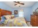 Cozy bedroom with charming wood furniture, a ceiling fan, and natural light from the window at 7020 N 375 E, Lebanon, IN 46052