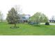 Charming blue two-story home with a landscaped front yard and inviting front porch at 7020 N 375 E, Lebanon, IN 46052
