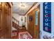Inviting foyer with hardwood floors, a staircase, and a decorative wreath on the front door at 7020 N 375 E, Lebanon, IN 46052