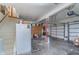 Large garage with a white refrigerator, cabinets, and ample space for vehicles and projects at 7020 N 375 E, Lebanon, IN 46052