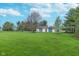 Spacious two-car detached garage surrounded by a well-manicured lawn and mature trees at 7020 N 375 E, Lebanon, IN 46052