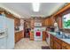 Charming kitchen with oak cabinetry, tile flooring, and stainless steel sink under a window at 7020 N 375 E, Lebanon, IN 46052