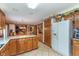 Functional kitchen with wooden cabinetry, tile floors, and access to other living areas at 7020 N 375 E, Lebanon, IN 46052
