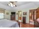 Spacious main bedroom with hardwood floors, ceiling fan, and dresser with television at 7020 N 375 E, Lebanon, IN 46052