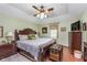 Serene main bedroom featuring dark wood furniture, a ceiling fan, and soft natural light at 7020 N 375 E, Lebanon, IN 46052