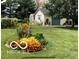 Exterior view of outbuilding surrounded by lush lawn and gardens with pops of orange flowers at 7020 N 375 E, Lebanon, IN 46052