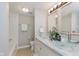 Bright bathroom featuring double sinks with vessel bowls, white cabinets, and modern lighting at 7404 Countrybrook Dr, Indianapolis, IN 46260
